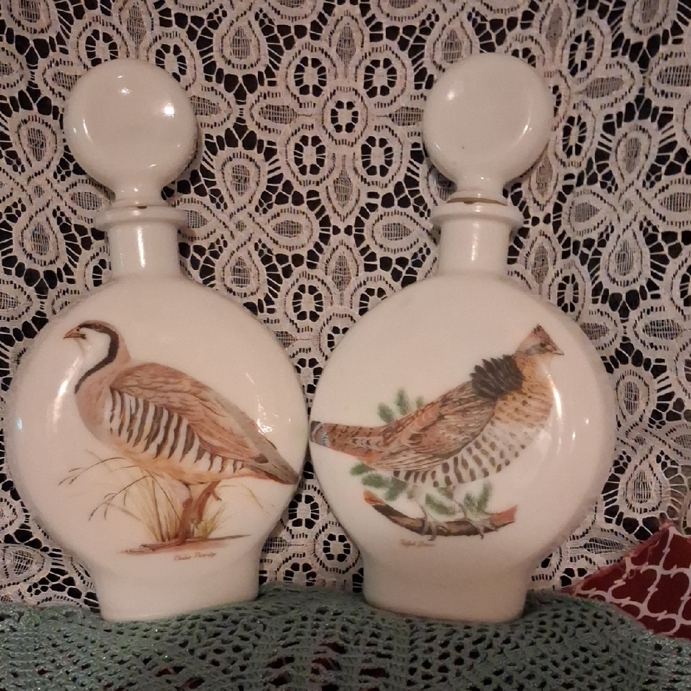 Pair of milk glass decanters titled 'Field Birds' by Arthur Singer, 1969